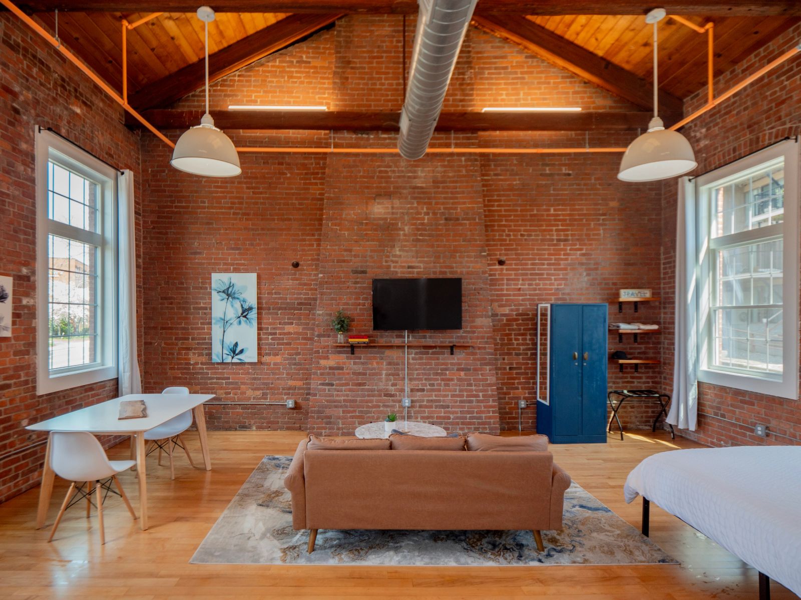 Bright brick loft living space at Stay Jennifer’s